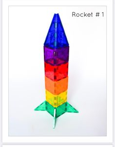 a multicolored plastic rocket sitting on top of a white table next to the words rocket 1