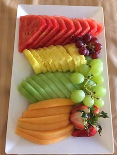 a white plate topped with cut up fruit