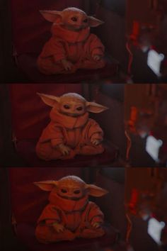 the baby yoda is sitting down and looking at something