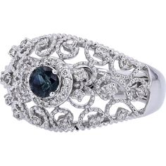 Gaze at the galaxy of glamour in this elegant 14K White Gold Sapphire Filigree Ring with Diamond Accents. Crafted to captivate, the centerpiece features a stunning sapphire, exuding a deep, enchanting blue hue. Delicate filigree work surrounds the center stone, adding an intricate touch of sophistication. Encircling the sapphire are sparkling diamonds, each meticulously set to enhance the brilliance of the ring. The combination of the vivid sapphire and the shimmering diamonds creates an aura of timeless elegance and refinement, perfect for elevating any ensemble with a touch of luxury.Indulge in the allure of fine craftsmanship and exquisite design with this breathtaking ring. Whether you're treating yourself or searching for the perfect gift for a loved one, this piece exudes grace and b Fine Jewelry Sapphire Ring With Filigree, Luxury Sapphire Ring With Intricate Design, Elegant Sapphire Filigree Wedding Ring, Elegant Blue Diamond Ring, Elegant Blue Sapphire Ring, Elegant White Gold Filigree Ring With Accent Stones, Elegant Sapphire Ring With Intricate Diamond Design, Elegant Sapphire Ring With Intricate Design, Elegant Sapphire Ring With Intricate Design For Anniversary