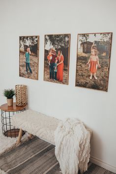 three pictures hang on the wall above a bench in a room with rugs and pillows