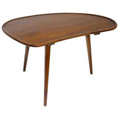 an oval wooden table with two legs and a curved top, on a white background