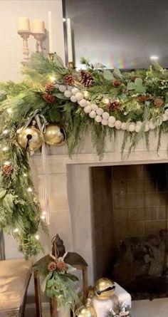 a fireplace decorated for christmas with greenery and ornaments