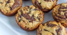 chocolate chip muffins are on a white plate