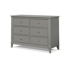 a gray dresser with six drawers and two doors on the bottom drawer, in front of a white background