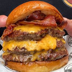 a bacon cheeseburger is shown in this photo