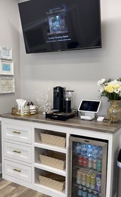 a coffee bar with a flat screen tv above it