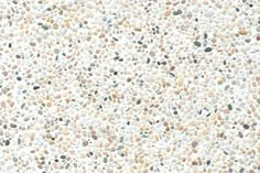 a white and black speckled surface with lots of small rocks on it's sides