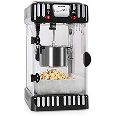 a popcorn machine with some food in front of it on a white surface and black trimmings