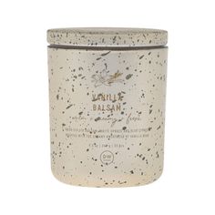 a white jar with black speckles on it