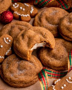 some cookies with white icing on them and one has a bite taken out of it