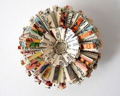 a small circular object made out of old books with words written on the inside and outside