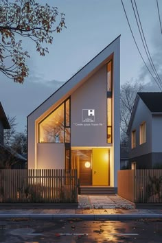 a modern house with an angled roof and glass windows