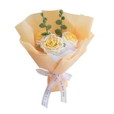 a bouquet of flowers is wrapped in yellow paper