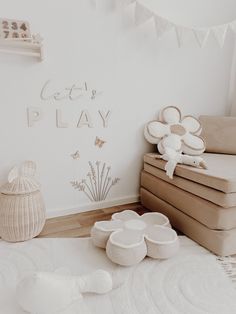 a white room with lots of furniture and decorations on the wall, including two baby cribs