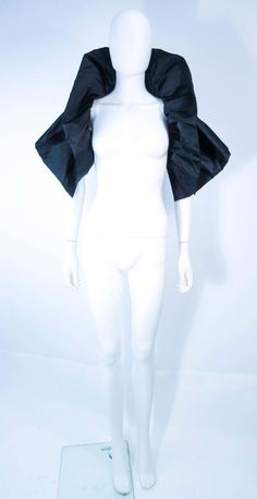 For Sale on 1stDibs - This Elizabeth Mason Couture 'Avant Garde' wrap is composed of a black silk. This wrap can be made to order in a variety of fabrics. An effortlessly chic Black Capelet For Evening Wear, Formal Black Capelet, Elegant Black Capelet With Cape Sleeves, Elegant Black Capelet For Party, Elegant Black Party Capelet, Chic Fitted Capelet For Formal Occasions, Black Fitted Capelet, Fitted Black Capelet, Elegant Black Formal Capelet