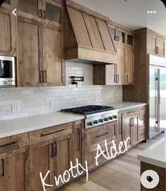 a kitchen with wooden cabinets and white counter tops, along with the words knotty alder above it