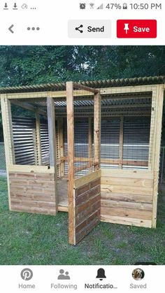 a small wooden structure with windows in the grass