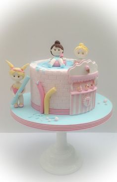 there is a cake with princess figures on it