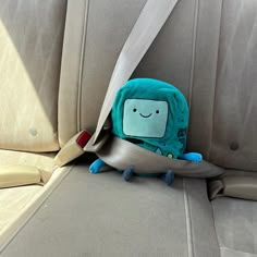 a stuffed animal sitting in the back seat of a car