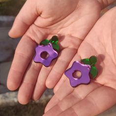 It's strange, but the taste reminds you of paradise. Your mind is filled with thoughts of happiness. These dangle earrings are inspired by Stardew Valley's Stardrop item. This purple fruit with green leaves boosts energy and makes you feel elated. They are shiny and reflective to add a little extra sparkle to your life. Order with the Default Stud to get the earring as pictured. If you would prefer an ear wire or hook, choose the Ear Hook option. Hooks are stainless steel and replace the green c Amity Blight Earrings, Junipurr Earrings, Steven Universe Earrings, Stardew Valley Earrings, Stardew Valley Clay Art, Stardew Valley Jewelry, Stardrop Stardew, Stardew Valley Stardrop, Purple Dangle Earrings