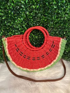 Adorable straw watermelon bag with a brown strap Handmade Red Bags For Summer, Red Handmade Bags For Summer, Cute Bucket Bags For Vacation, Cute Bucket Bag For Vacation, Cute Summer Bag With Adjustable Strap, Cute Vacation Shoulder Bag, Cute Shoulder Bag For Vacation, Cute Handmade Beach Bags, Summer Green Handheld Straw Bag