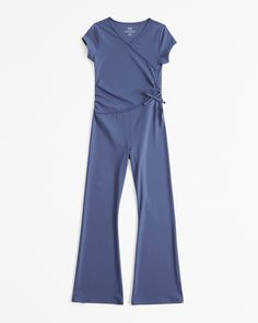 Versatile short-sleeve jumpsuit in a synthetic active fabric, with on-trend wrap detail, v-neckline and pockets. Short Sleeve Jumpsuits, Abercrombie Kids, Dresses Kids Girl, Dress Romper, Ribbed Fabric, Size 13, Jumpsuit Romper, Girls Dresses, Jumpsuit