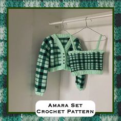 two green and white sweaters hanging on a clothes rack next to a coat hanger