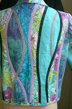 the back of a woman's blouse with colorful patterns