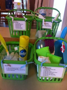 three green plastic baskets filled with cleaning products on top of a wooden table next to a mirror