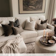 a living room filled with white furniture and pillows