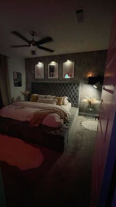 a bedroom with a bed and ceiling fan