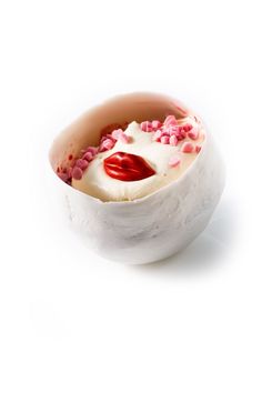 a white bowl filled with red and pink sprinkles on top of a white surface