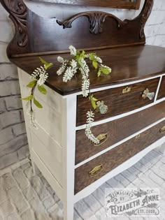 an old dresser has flowers growing on it