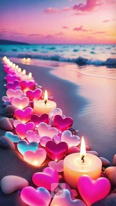 hearts lined up on the beach with candles