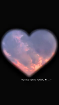 a heart shaped object with the sky in the back ground and clouds in the background