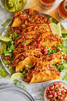 tacos and guacamole on a plate with salsa