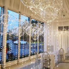 a room filled with tables and chairs covered in lights