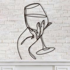 a drawing of a hand holding a wine glass in front of a white brick wall