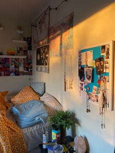 a bed room with a neatly made bed and pictures on the wall