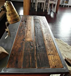 a wooden table sitting in a room next to other items and tools on the floor