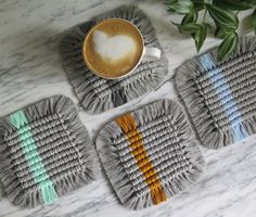 three coasters with different colors and designs on them next to a cup of coffee