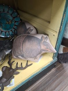 stuffed animals are on display in a cabinet