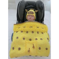 a baby in a car seat wearing a yellow blanket