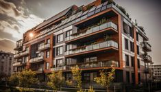 an apartment building with many balconies and plants on the balconys at sunset