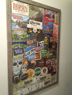 a bulletin board with many different types of beer labels hanging on it's wall