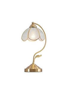 a lamp that is on top of a white tablecloth with a gold base and glass shade