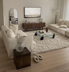 a living room filled with furniture and a flat screen tv mounted on the wall above it