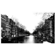 black and white photograph of canal in city