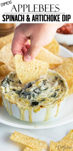 spinach and artichoke dip in a white bowl with tortilla chips